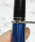 Pro Grade Heavy Duty Fountain Pen Repair and Disassembly Wrench in use on blue striped pen