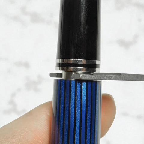 Pro Grade Heavy Duty Fountain Pen Repair and Disassembly Wrench in use on blue striped pen