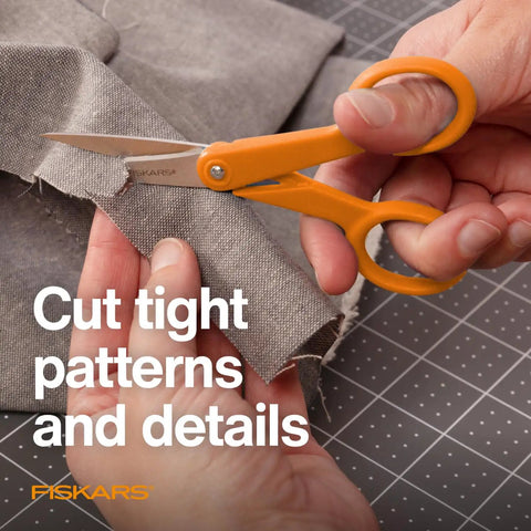 Premium No.5 Micro-Tip Fabric Scissors with orange handle cutting fabric, ideal for intricate patterns. Premier No 5 Micro Tip Orange Handled Fabric Scissors With Double Loop Handle For Precise Sewing Crafting And Detail Cutting Of Intricate Patterns For Tiny Details And Tight Patterns On Fine Fabrics And Delicate Projects.