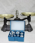 Open box of Pro Grade Calibration Weight Set for Digital Balances and Jewelry Scales, 16-piece under vintage brass scale