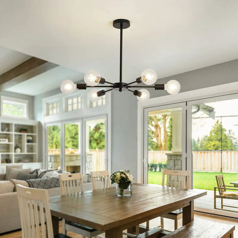 Six Light Sputnik Black Chandelier With Adjustable Height Ceiling Light Fixture For Kitchen Dining Living Room And Bedroom Mid Century Modern Pendant Lighting E26 Bulb Compatible shown over dining table in bright room.
