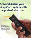 Hand holding remote control for 12 Piece Wireless Home Security System Kit With HD Camera, Optional 24 Seven Professional Monitoring
