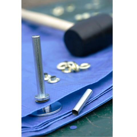 Close-up of Grommet Kit With Tools For Canvas And Leather Repairs 20 Piece Camping Grommets Set on blue fabric with tools visible