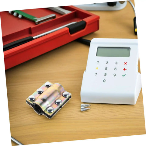 Heavy Duty Pipe Repair Clamp for Plastic and Metal on table, with electronic device and toolbox in background.