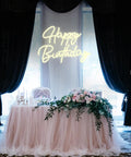 Smile Face Neon Sign Birthday Light 13 By 13 Inches Portable USB Powered Warm White Glow For Parties Take Anywhere Easy To Install With 2 Meter USB Cable Photo Backdrop And Party Ready Decor For Events above a party table with flower arrangement