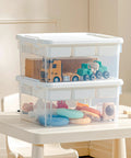 Stacked No Fuss 17 Qt Clear Plastic Storage Box With Bricks Compatible Baseplate Lid on table holding toys and craft supplies.