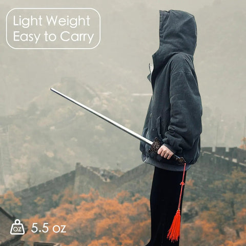 Person holding 36 Inch Tai Chi Training Sword With Retractable Design, lightweight and easy to carry, with scenic background.
