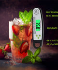 Digital Meat Thermometer For Grilling With Backlit Display, Instant Read In 2 To 4 Seconds next to a glass of strawberry mint drink