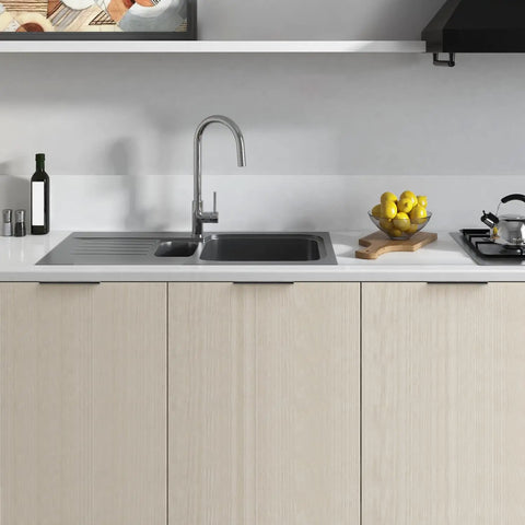 Modern kitchen with matte black 5 inch finger edge cabinet pulls on light wood cabinets, sleek design