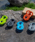 Snatch Block 12 Ton Heavy Duty Winch Pulley For Off Road Recovery in various colors on rocky outdoor surface