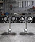 Close-up of Heavy Duty 4 Wheel Trolley Assembly Rollers With Rust Resistant Galvanized Body High Carbon Steel Core on workbench.