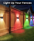 Level Up Your Backyard With Badass Multicolor Solar Fence Lights That Bring Sick Lighting Vibes And Weather Resistant IP67 Design For Patios Porches Gardens And Garages Featuring Dusk To Dawn Sensor Six Pack illuminating a wooden fence.