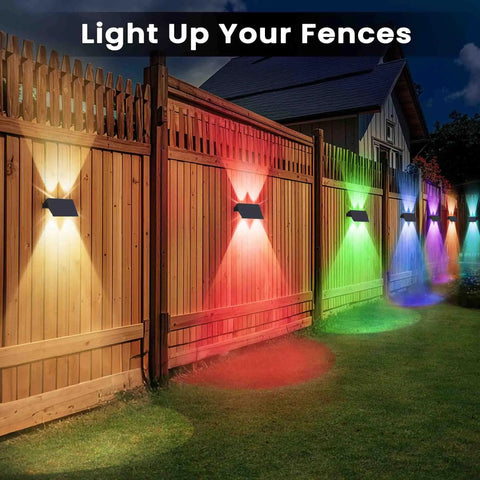 Level Up Your Backyard With Badass Multicolor Solar Fence Lights That Bring Sick Lighting Vibes And Weather Resistant IP67 Design For Patios Porches Gardens And Garages Featuring Dusk To Dawn Sensor Six Pack illuminating a wooden fence.