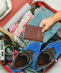 Suitcase with clothes, camera, passport, and shoes with Blue Non Slip Waterproof Disposable Shoe Covers Thick Stretchable Boot Covers Fit Most Shoes Protect Floors And Carpets From Dust Mud Debris Dustproof And Tear Resistant Easy To Use Pack Of 50 Pairs.