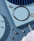 4 Sizes Stainless Steel Cord End Caps Set For Jewelry Making, 40 Pcs Total, displayed with bracelet on blue surface
