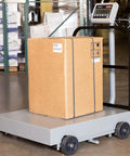 Real Sturdy Heavy Duty Mobile Shipping Scale 400 Lb Capacity With Massive 31 By 27 Inch Platform showing a box on the scale in a warehouse.