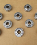 10 Pack Straight Shooter Deep Groove Ball Bearings Replacement Kit AA21480 DG1645-2RS GA2014 sealed chrome steel units on brown background.