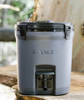 Adventure Fast Flow 2 Gallon Water Jug With Leakproof Ice Dispenser Easy Pour Spigot Latched Foam Lid on a wooden bench