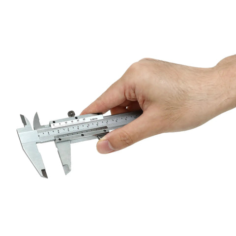 Hand holding Vernier Caliper 0-6 Inch / 0-150 Millimeters Manual Caliper Carbon Steel Pro Grade Built To Last With Knurled Thumb Roller