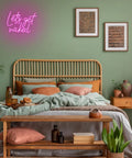 Lets Get Naked Pink Neon Sign For Bedroom Decor LED Neon Light Wall Art above bed with wooden headboard and green wall