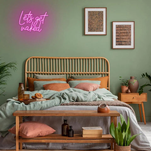 Lets Get Naked Pink Neon Sign For Bedroom Decor LED Neon Light Wall Art above bed with wooden headboard and green wall