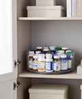 Straight Up Smooth Lazy Susan Turntable Organizer Featuring Ultra Glide Rotation And Smart Three Compartment Design For Zero Hassle Vitamin Pill Medicine Storage On Bathroom Vanities Or Kitchen Counters in a cabinet with clear tray and medicine bottles.