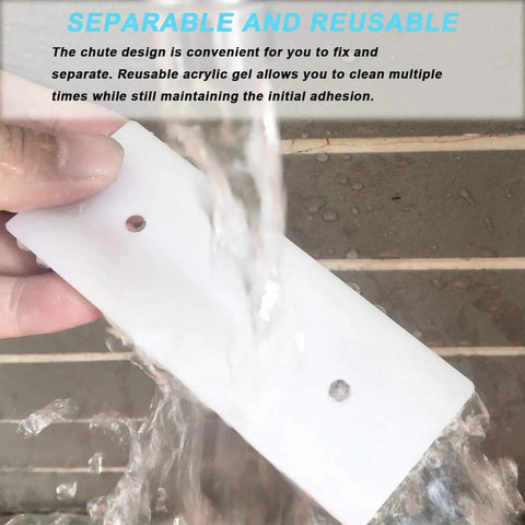 Person cleaning Four Pack Self Adhesive Power Strip Holders Wall Mount Brackets under water, showcasing reuse and durability.