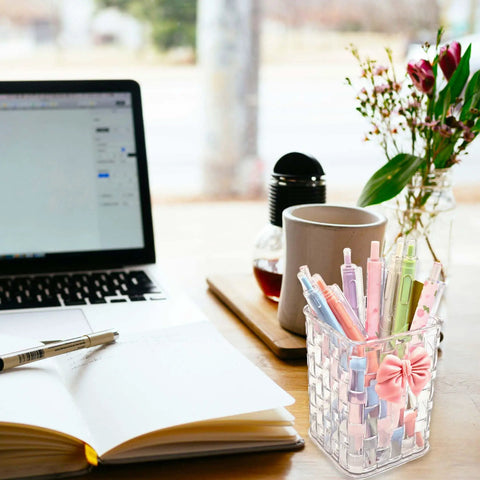 Clear White Acrylic Desk Pen And Makeup Brush Holder With Woven Texture Bow Accent, Must Have Stylish Caddy For Office Home School Kitchen, Keeps Pens Pencils Brushes Organized And Looking Sharp on a desk next to a laptop and notebook