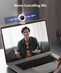 NexiGo N970P 4K Webcam With Onboard Storage, AI Auto Framing, shown on laptop with noise-cancelling features in use