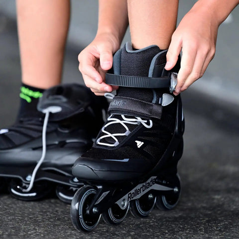 Person fastening Zetrablade Inline Skates For Adults Unisex Black Silver Size 40 And A Half Easy Kickoff For Beginners with high cuff