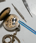 Titanium Alloy Tweezers Compact Machining Clamp Mini Travel Tool on workbench with watch and screwdriver visible