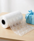 Inflatable Bubble Cushioning Roll For Shipping And Moving 984 Ft 300 M Of Air Filled Bubble Film next to a blue gift box