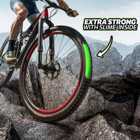 Cyclist on mountain with Extra Strong Self Sealing Bicycle Tube 26 Inch By 1.75 To 2.125 Inch Schrader Valve, green slime visible