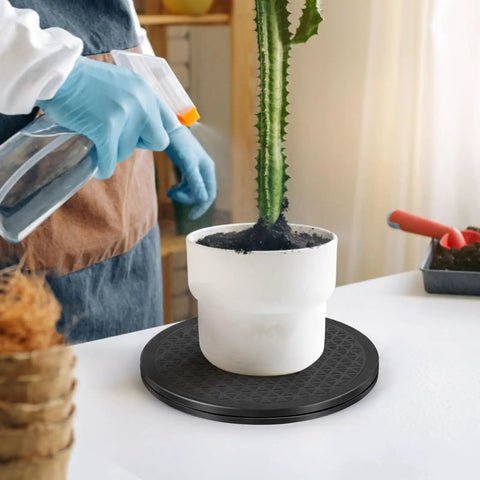 Heavy Duty Lazy Susan 10 Inch With Steel Ball Bearings supports potted plant care on a black turntable while being watered.