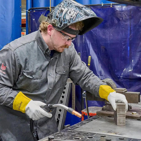 Man wearing Cowhide Welding Gloves SafeGear For Tig Welding Wing Thumb EN388 3131 Certified Medium 2 Pack at workbench