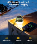 Rechargeable Camping Lantern With 5000mAh Battery, 400 Hour Runtime, illuminating outdoor setting with a smartphone charging nearby.