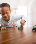 Child playing with Deluxe 3 Pack John Deere Farm Toy Set With Free Rolling Wheels Tractors Gator And Skid Steer In Collectible Display Box