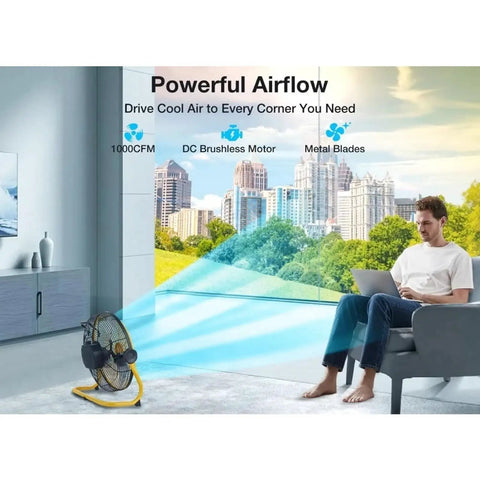 12 Inch Cordless Floor Fan Built With Rugged Metal Frame And Brushless Motor For Slick High Velocity Airflow Perfect For Camping Or Garage Use Featuring Zero Plug Hassle And Heavy Duty Reliability, positioned near a man working.