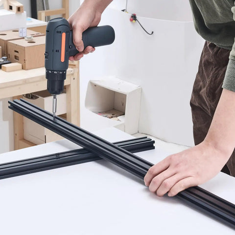 Person assembling Four 39.4 Inch T Slot 2040 Aluminum Extrusion Profiles With Anodized Linear Rails European Standard Heavy Duty DIY Kit