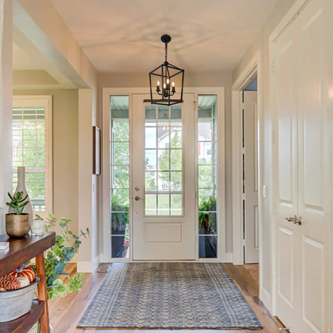 4 Light Black Farmhouse Chandelier With Industrial Iron Lantern Cage Pendant Light displayed in a bright foyer