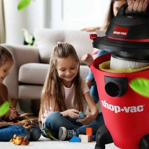 Children playing in a living room with a Pro-Grade High-Efficiency Disposable Vacuum Filter Bags For 5 To 9 Gallon Vacuums in a red Shop-Vac.