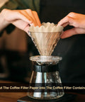 Person placing a natural brown unbleached coffee filter into a pour-over brewer, Bulk 100 Count One To Four Cup Disposable Coffee Filters Natural Brown Unbleached Basket Style For Home And Office Use Great For Pour Over And Drip Coffee Makers