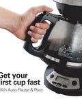 Hand holding 12 Cup Programmable Drip Coffee Maker With Auto Pause And Pour Glass Carafe Regular And Bold Brew Options Black With Stainless Accents Wake Up Ready Coffee Easy Touch Timer Fast First Cup