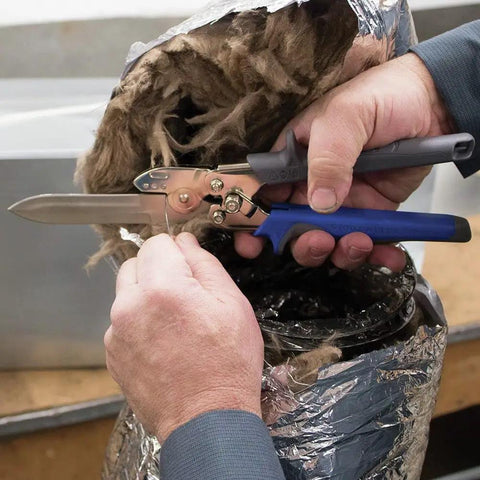 Heavy Duty HVAC Cutter Tool With Built In Wire Cutter cutting flexible duct, featuring all-steel double edge blades and contoured grips