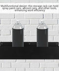 Wall Mount Spray Can Holder And Tool Rack Heavy Duty Metal Storage Shelf with two aerosol cans against brick wall
