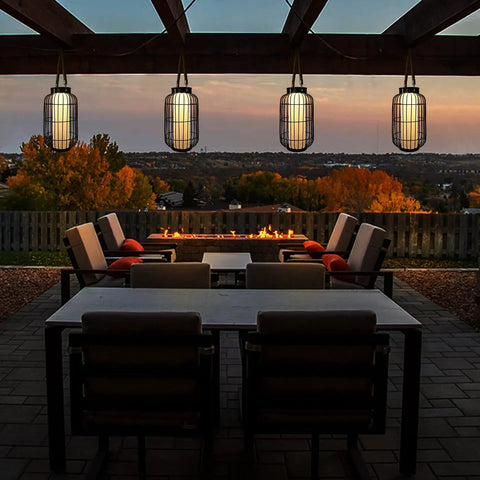 Big Solar Powered Lantern for Outdoor Use Heavy Duty Metal Hanging Lights illuminating a patio during sunset.
