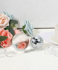 Set Of 15 Clear Ball Display Stands For Baseballs Softballs Golf Balls And Tennis Balls Round Sphere Holders next to flowers and cups