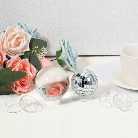 Set Of 15 Clear Ball Display Stands For Baseballs Softballs Golf Balls And Tennis Balls Round Sphere Holders next to flowers and cups