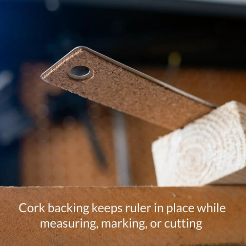 Close-up of Heavy Duty Stainless Steel Ruler 24 Inch With Cork Backing showing the non-slip cork edge on a wooden surface.