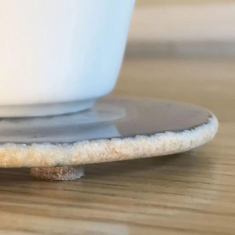 Three-Eighths Inch Round Mini Self-Stick Furniture Felt Pads For Hard Floors showing felt pad on plate bottom.